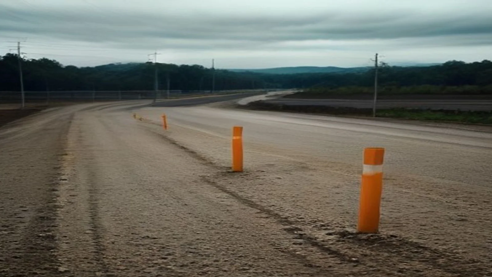 Prepared roadside land: future site marked out with a power line nearby